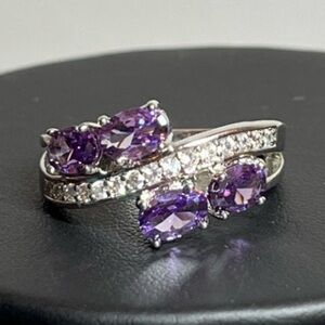 Silver tone statement ring with purple accents
Size 8